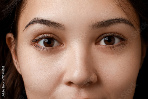 Young Asian woman with brown eyes, closeup