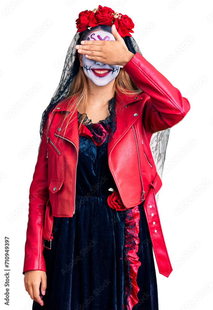 Woman wearing day of the dead costume over background smiling and laughing with hand on face covering eyes for surprise. blind concept. Woman wearing day of the dead costume over background smiling and laughing with hand on face covering eyes for surprise. blind concept.