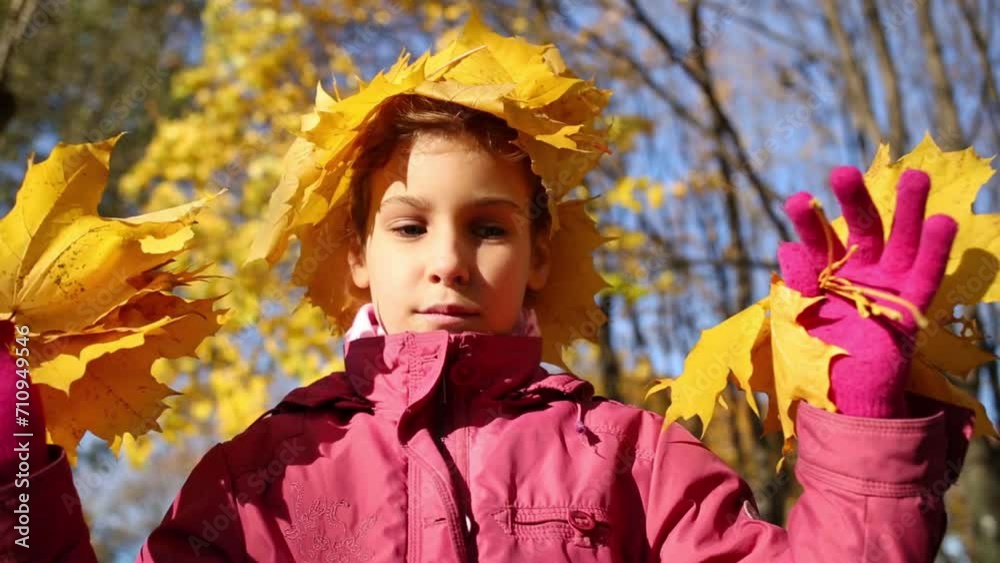 Little girl with crown made of maple yellow leaves holds leaves Little girl with crown made of maple yellow leaves holds leaves