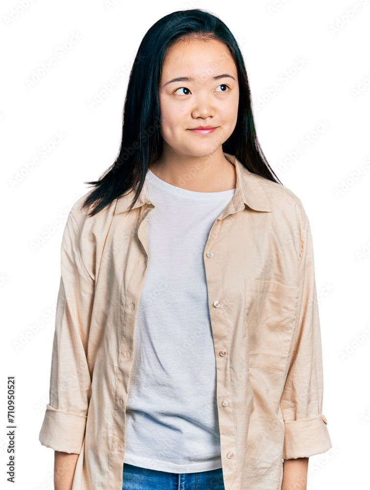 Young chinese woman wearing casual white t shirt and jacket smiling looking to the side and staring away thinking. Young chinese woman wearing casual white t shirt and jacket smiling looking to the side and staring away thinking.