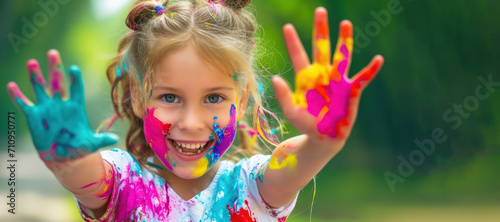 happy child 10 years old hands and face in multi-colored paint. shows painted hands. Concert happy childhood  pranks  children  joy girl boy