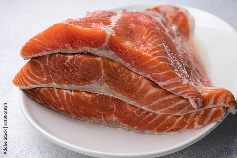 fresh, delicious salmon fillet on a white plate fresh, delicious salmon fillet on a white plate