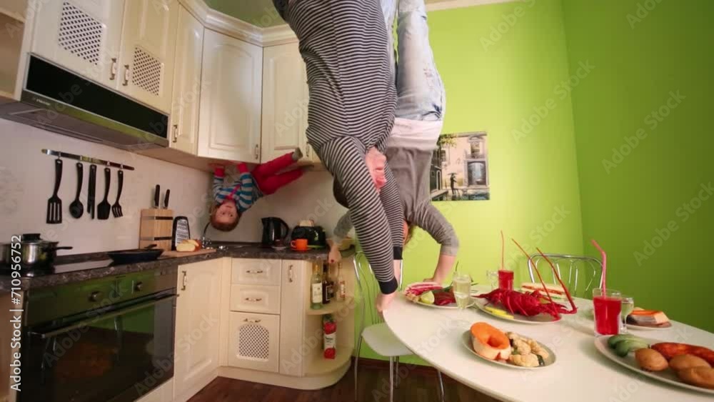 Parents and daughter upside down touch table in inverted house Parents and daughter upside down touch table in inverted house