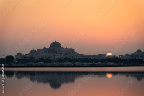 Abu Dhabi skyline at the sunset with silhouette of the presidential palace Qasr Al Watan