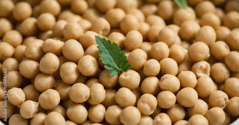 A closeup of a heap of cooked chickpeas, the main ingredient for hummus, isolated on a white background.