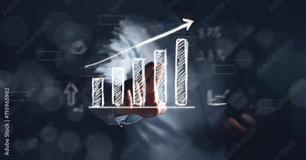 Businessman draws an increasing trend arrow and a rising chart - obrazy, fototapety, plakaty 