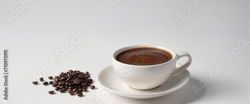 Top view of steamy espresso and coffee beans on white table with soft focus and backlight