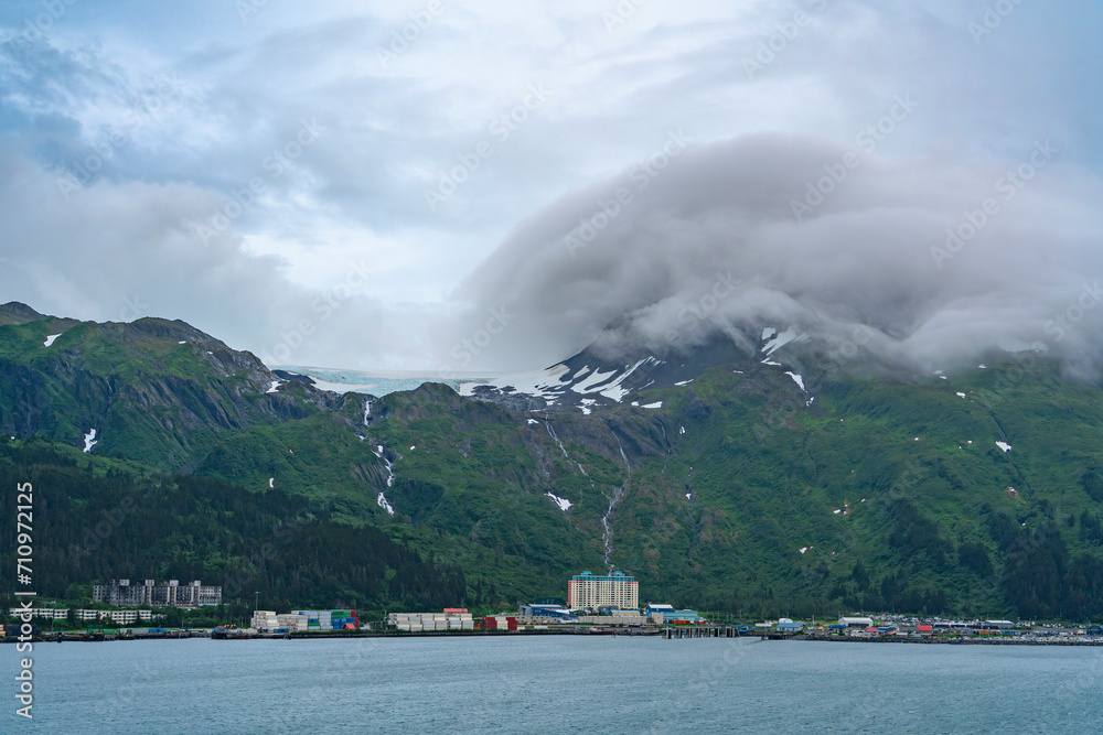 landscape view of Whittier town in Alaska and surrounding snow capped mountain in cloud