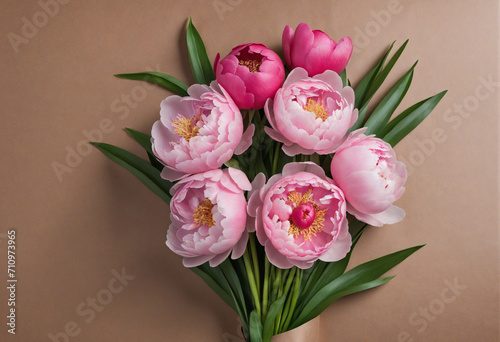 Sending a bouquet of pink peonies on rustic wrapping paper to a friend at home.
