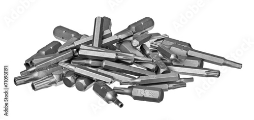 Close-up a pile of steel screwdriver bits of different type and size isolated on a white background. Kit of interchangeable security torx and hex screw drivers. Heap of various metal tightening tools.