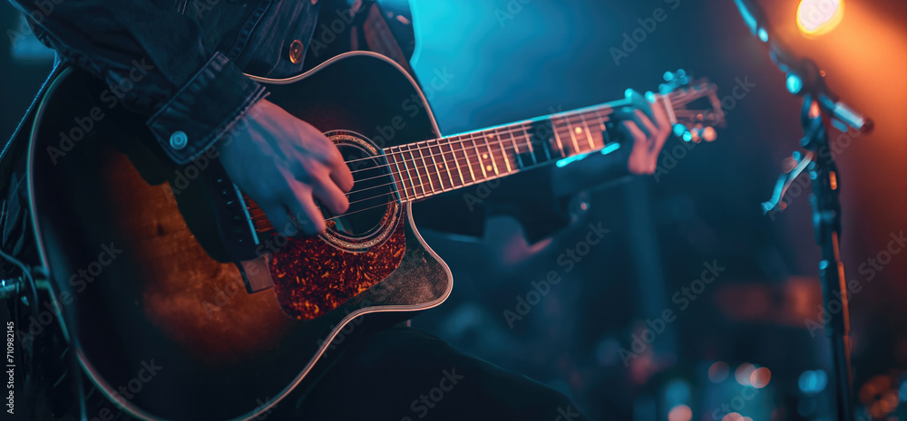 Obraz premium Guitarist plays guitar on stage performance at a concert guitarist hands close-up