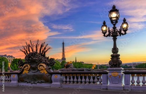 Street lantern on the Alexandre III Bridge with the Eiffel Tower in the background in Paris, France. Architecture and landmarks of Paris. Sunset cityscape of Paris