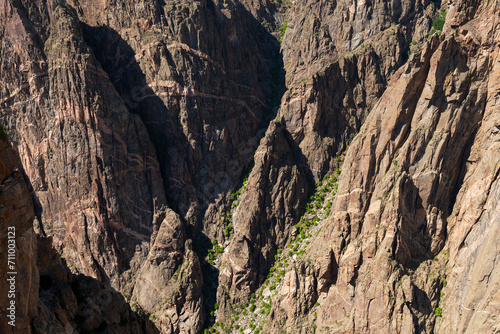 Massive rocks in shadows and light in the depths of the Black Canyon of the Gunnison River national park, Colorado, USA.
