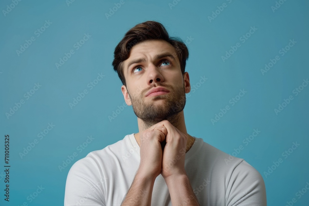 A man in a white shirt looking up. Suitable for various concepts and designs