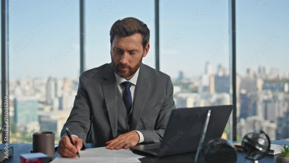 Man entrepreneur writing papers in contemporary office. Successful boss signing