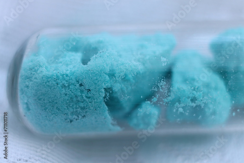 Obraz na plátně Nickel sulfate crystal hydrate of turquoise color in a test tube.
