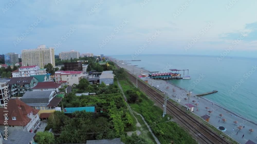 Coastal town with railroad near sea beach at summer evening Coastal town with railroad near sea beach at summer evening