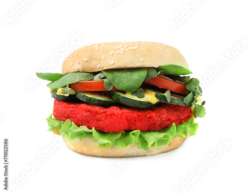 Tasty vegan burger with vegetables, patty and microgreens on white tiled table, closeup