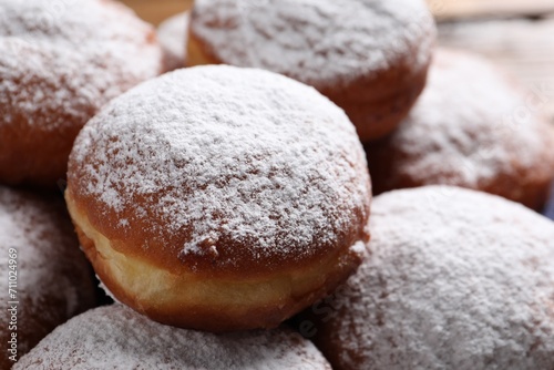 Delicious sweet buns with powdered sugar as background, closeup