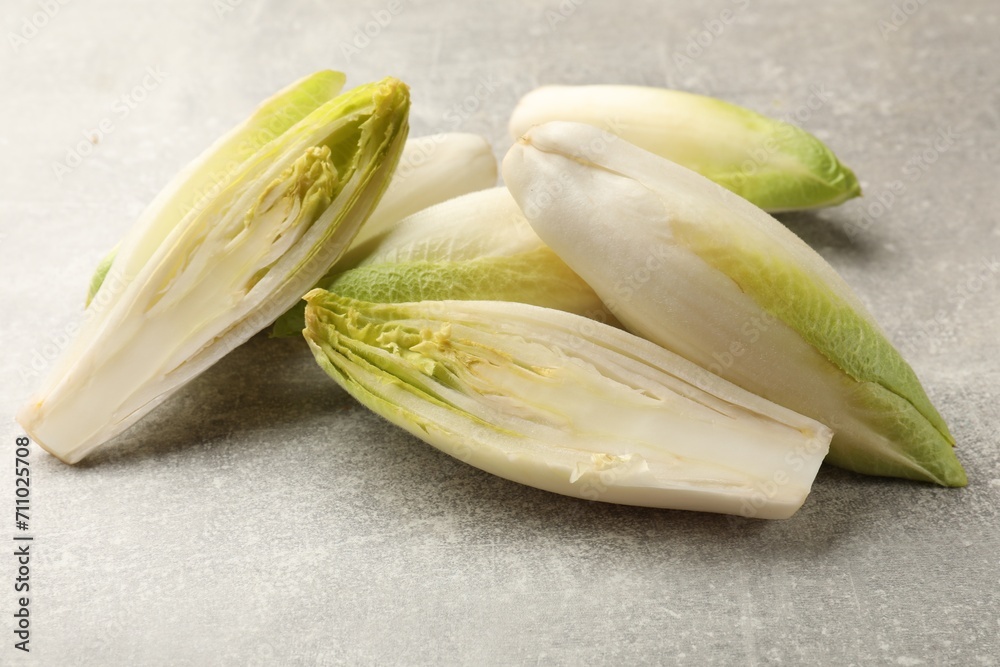 Fresh raw Belgian endives (chicory) on light grey table Fresh raw Belgian endives (chicory) on light grey table