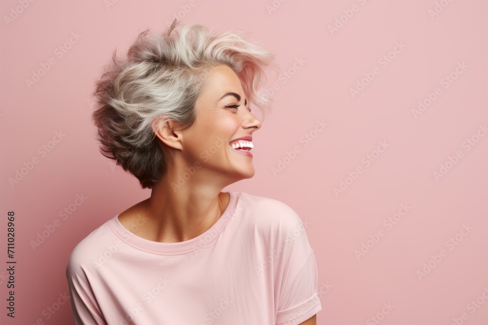 Beautiful middle aged woman with short gray hair on pink background. Beautiful middle aged woman with short gray hair on pink background.