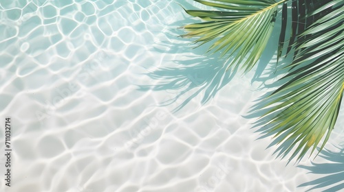 top view of water surface with tropical leaf shadow. Shadow of palm leaves on white sand beach. Beautiful abstract background concept banner for summer vacation at the beach. 