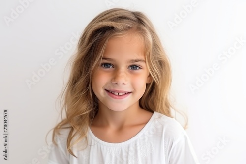 Portrait of a beautiful little girl with long blond hair on a white background