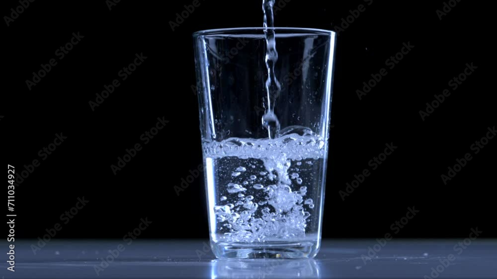 Closeup of Pure Water Pouring into Glass - Bubbling and Filling Closeup of Pure Water Pouring into Glass - Bubbling and Filling