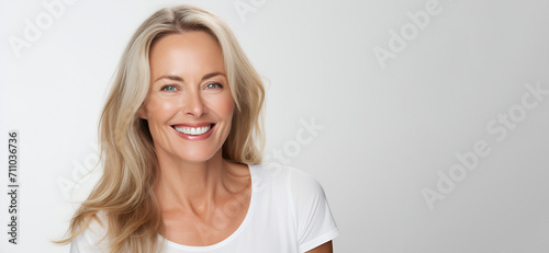 Beautiful middle-aged woman on a gray background.