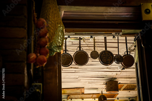 cooking utensils hanging on the wall of a kitchen