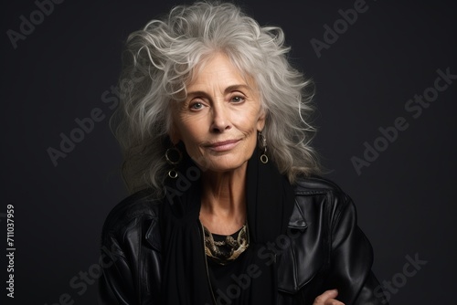 Portrait of a beautiful senior woman in a black leather jacket.