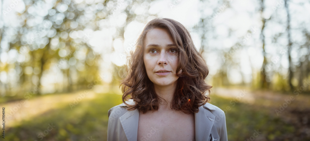 beautiful woman 30 years old in the summer in a sunny park, portrait with shallow depth of field of a beauty