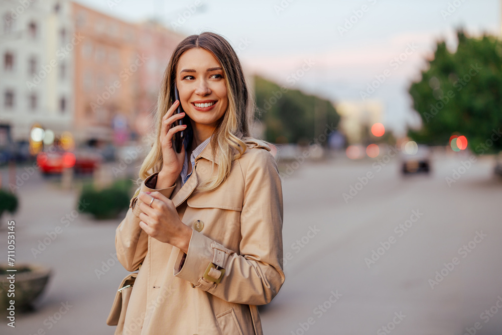 Portrait of a trendy woman having phone call on a street. Portrait of a trendy woman having phone call on a street.