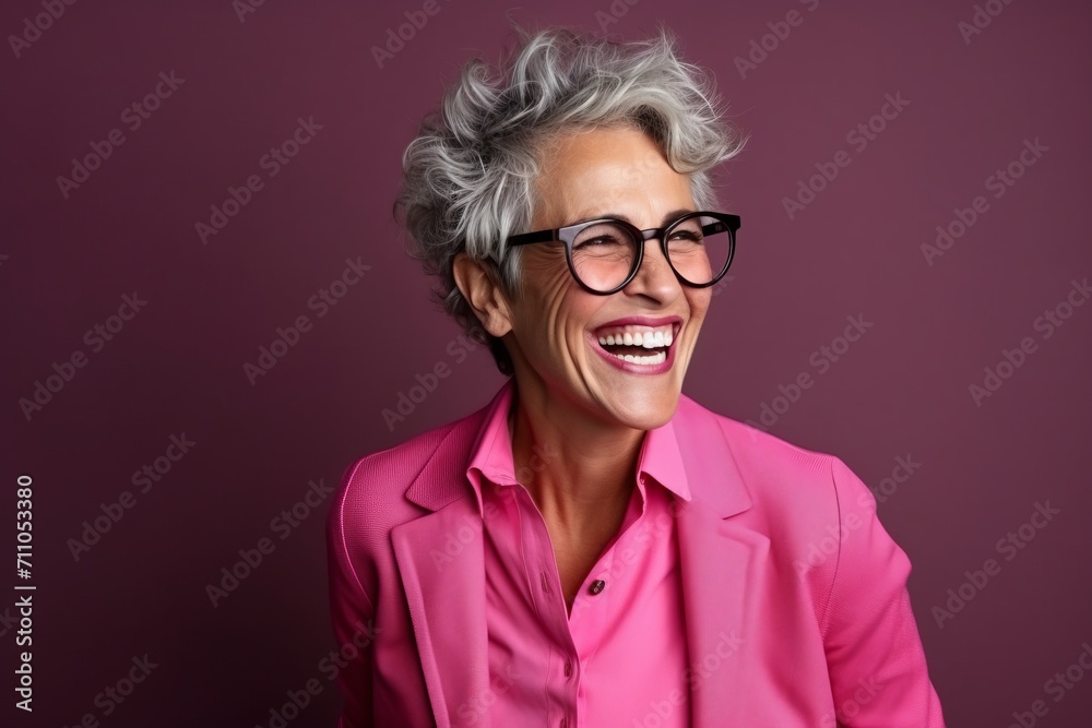 Portrait of a happy senior woman in glasses over purple background. Portrait of a happy senior woman in glasses over purple background.