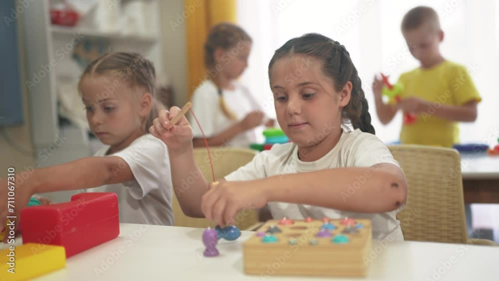 child group playing fishing. children in kindergarten play with toys. happy family kid dream concept. a group of children collect building blocks in a kindergarten indoors lifestyle child group playing fishing. children in kindergarten play with toys. happy family kid dream concept. a group of children collect building blocks in a kindergarten indoors lifestyle