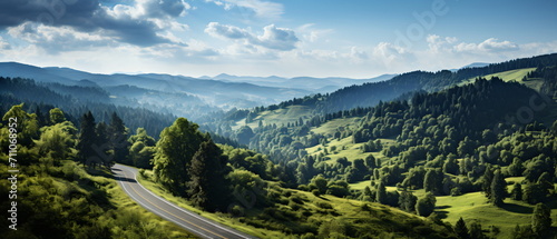 Scenic view of a winding road through green hills and forests