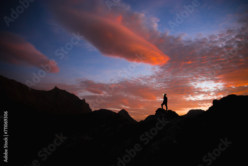 silhouette of a person on a rock