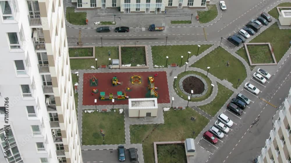 Playground among modern buildings near parking. Time lapse. Playground among modern buildings near parking. Time lapse.