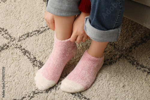 Woman in warm pink socks at home