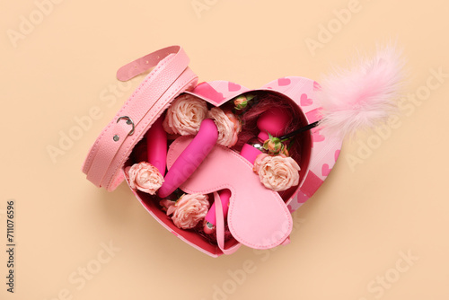 Bilde på lerret Pink heart shaped gift box with sex toys, blindfold, feather tickler and flowers