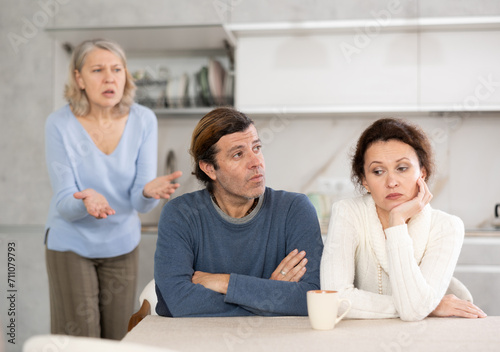 Outraged elderly female pensioner scolds her son and daughter-in-law for infantile behavior, unworthy behavior