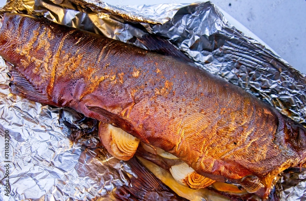 Whole salmon smoked and grilled with onion and lemon