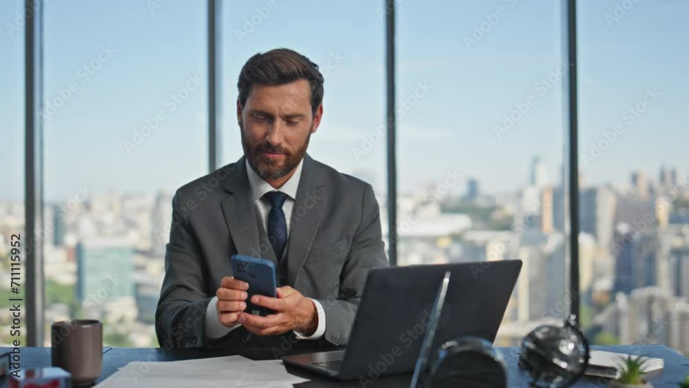 Smiling accountant looking computer browsing online. Company worker using cell Smiling accountant looking computer browsing online. Company worker using cell