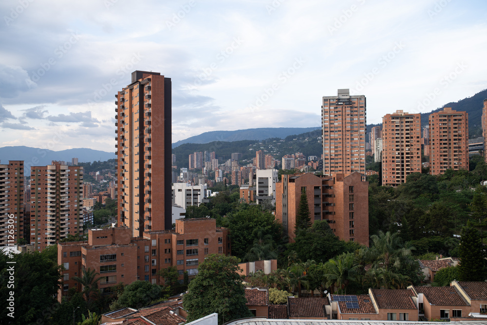 tall brick buildings in latin american capital with mountains in background