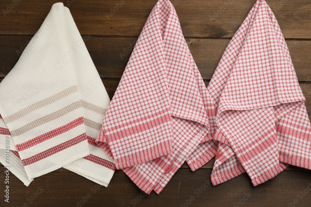 Different kitchen towels hanging on wooden wall Different kitchen towels hanging on wooden wall