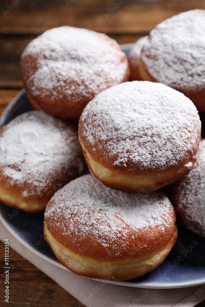 Delicious sweet buns with powdered sugar on table, closeup