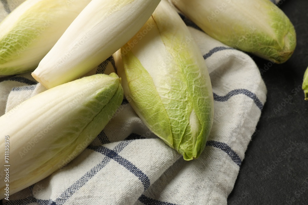 Fresh raw Belgian endives (chicory) on black table, closeup Fresh raw Belgian endives (chicory) on black table, closeup