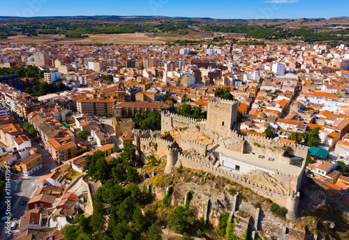 View from drone of historic center of Spanish city of Almansa overlooking ancient fortified Castle and bell-tower of Roman Catholic Church, province of Albacete photo