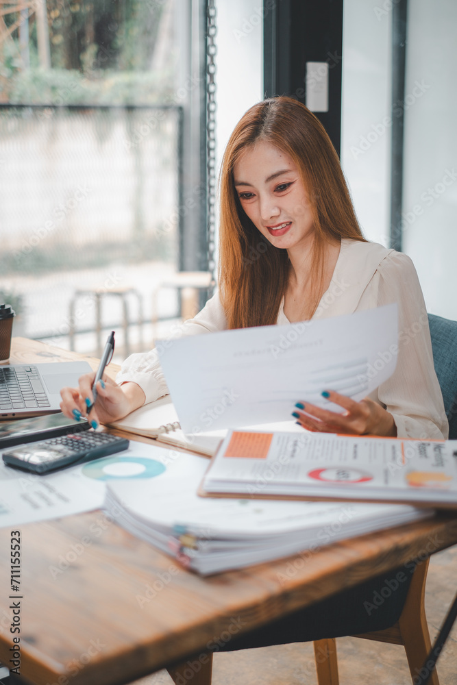 Business woman manager accounting analyst checking bills, analyzing sales statistics management, taxes financial data documents or marketing report papers working in office Business woman manager accounting analyst checking bills, analyzing sales statistics management, taxes financial data documents or marketing report papers working in office