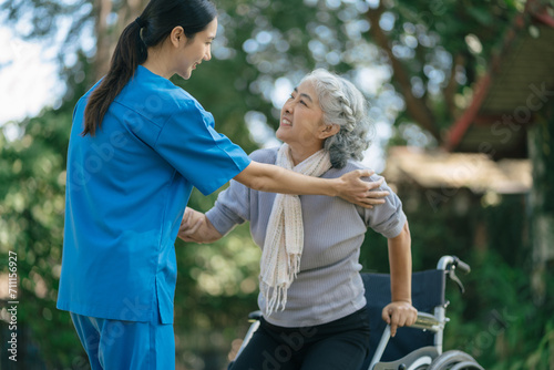 Professional physiotherapist taking care of senior patient during rehabilitation. © NINENII